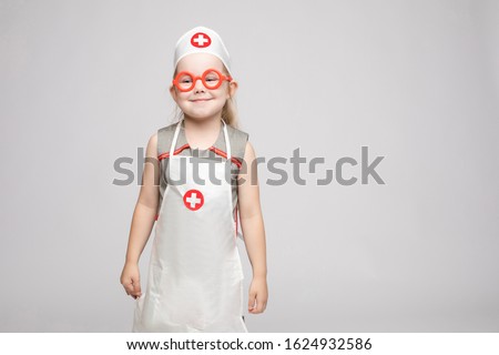Adorable girl in doctor's uniform.She is a doctor.