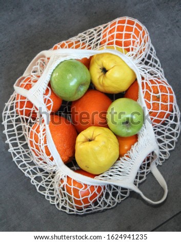 Fruits in cotton mesh bag. Zero waste ecology concept.