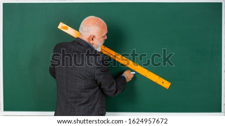 draw line. bearded tutor man draw with ruler on blackboard. back to school. school disciplines. Education and knowledge. geometric shapes at high school. senior man teacher use ruler while drawing.