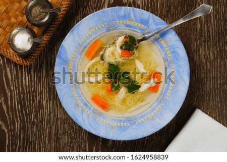 Chicken broth. Tasty rich soup with vegetables, chicken and noodles