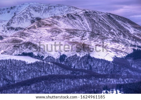 Tarcu mountain range silhouette during cold, snowy winter. Photo taken in 12th of January 2020 on Southern part of the Carpathian Mountains, Romania.