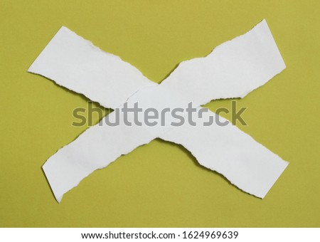 pieces of torn paper on yellow background. copy space