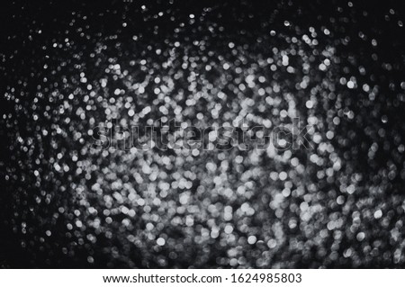 Minamalist black festive glittering defocused abstract background with bokeh lights