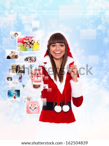 christmas girl happy smile hold cell phone mobile present, woman wear Santa Clause costume show touch screen, new year communication concept over background