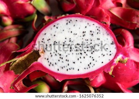 Fresh organic Pitahaya dragon fruit cut on the white board. Copy space. in halves and served