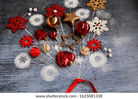 Fantasy on the theme of the New Year. Christmas balls, snowflakes, stars in the form of balloons tied with a red ribbon on a dark blue background