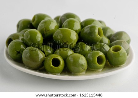 Olives. Imported traditional classic Greek olives marinated in extra virgin olive oil and seasoned with herbs and spices. 