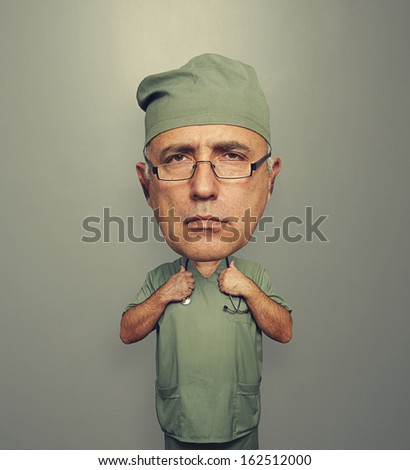 serious bighead doctor in glasses over grey background