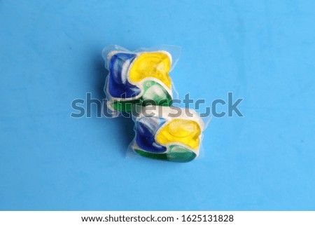 dishwasher capsule in colored background