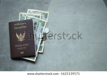 Thailand passport and money for travel in Japan. Concept of travel in Japan