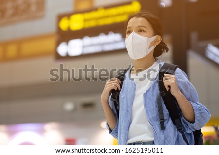 Asian travelers girl with medical face mask to protection the coronavirus in airport  Royalty-Free Stock Photo #1625195011