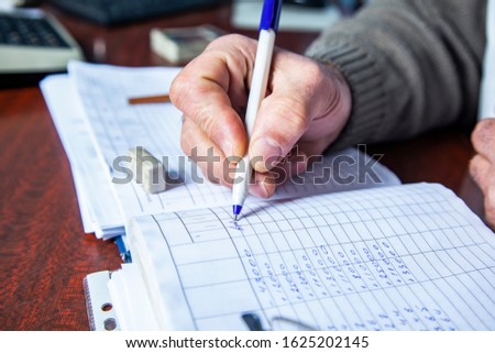 man hand pen with document on the desk