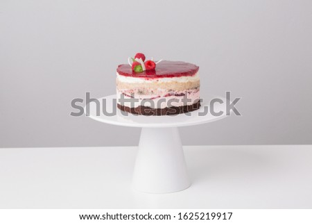 close up of conceptual fruit cake on gray background