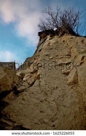 A photo of a rocky sandstone sea cliff from the bottom in Gdynia, Poland