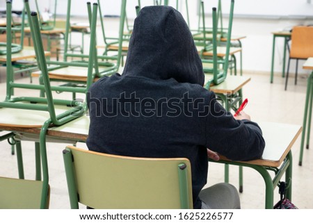 portrait of the back of a young girl sat in a classroom at school, education concept Royalty-Free Stock Photo #1625226577