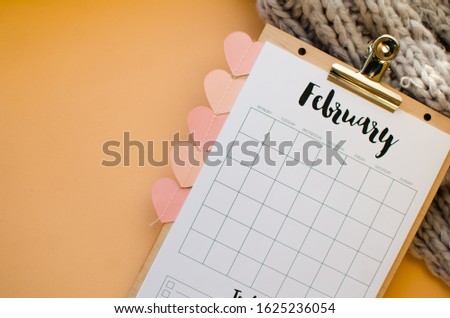 Simple desk calendar for February 2020. Place for text. Deadline concept with sheet of monthly calendar. St Valentines concept. Heart on the background.