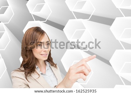 Composite image of businesswoman pressing an invisible key 