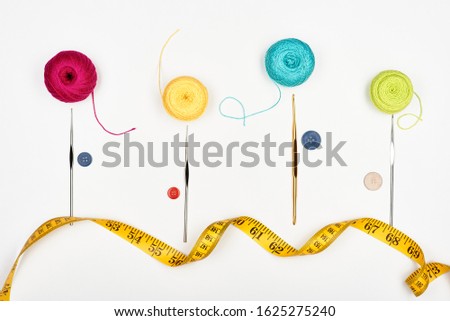 Colorful composition from accessories for embroidery. White background. Top view.