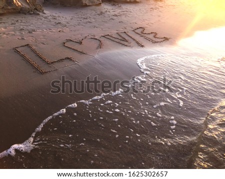 Text Love on the sand on the beach. Vacation on the sea. Sunset ocean