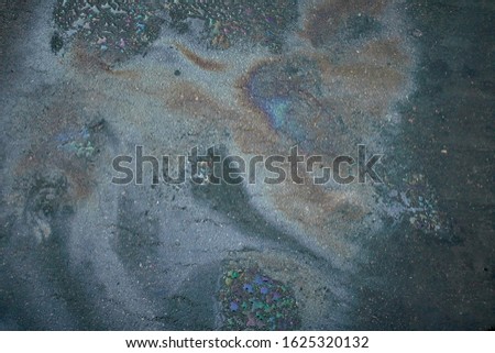 Abstract background with oil stain of oil products.Oil stain on Asphalt, color Gasoline fuel spots on Asphalt Road as Texture or Background.