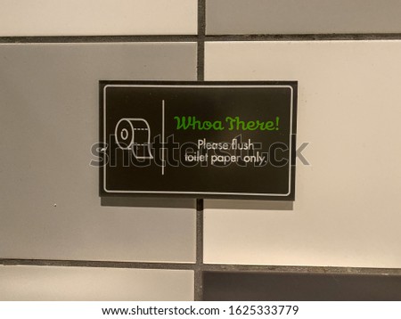 A sign signifying to flush Toilet Paper only in a public bathroom.