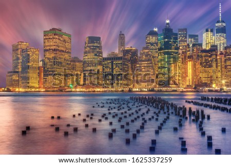 Lower Manhattan and an old Brooklyn pier at dusk