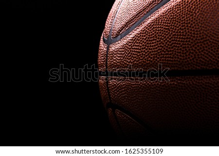 basketball ball on black background .