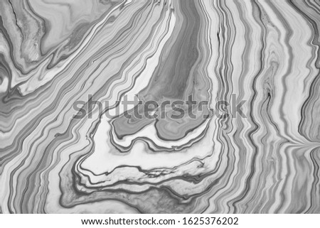 Mixed black and white acrylic paint. Marble effect. Abstract background for design.