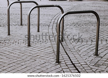 a metal structure for Parking bicycles or scooters, environmental transport in the city. Moving by bike every day. bicycle at street parking outdoors