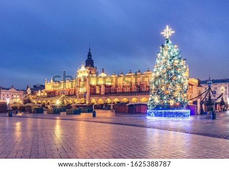 Krakow, Poland, Main Square and Cloth Hall in the winter season, during Christmas fairs decorated with Christmas tree.