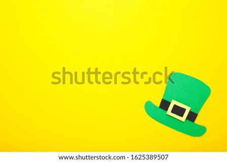 St Patrick's Day Leprechaun hat on yellow background with copy space.