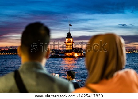 Fiery sunset over Bosphorus with famous Maiden's Tower (Kiz Kulesi) also known as Leander's Tower, symbol of Istanbul, Turkey. Scenic travel background for wallpaper or guide book