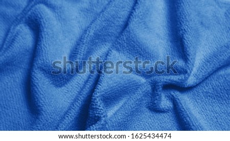 Classic blue colour monochrome texture  knitted fabric. Blue woll knitted Jersey as textile background. Classic blue color background. Wool knitting texture. Trendy color 2020. 