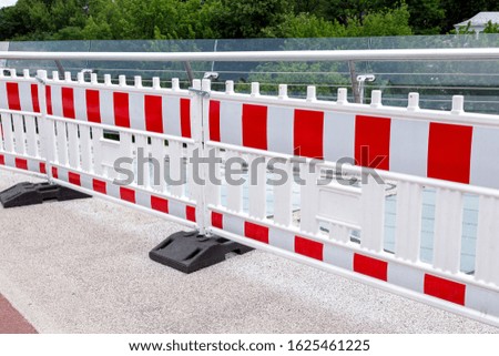Barrier warning fencing of a dangerous place on a glass bridge, nobody.