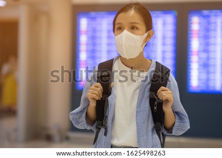 Asian travelers girl with medical face mask to protection the coronavirus in airport  Royalty-Free Stock Photo #1625498263