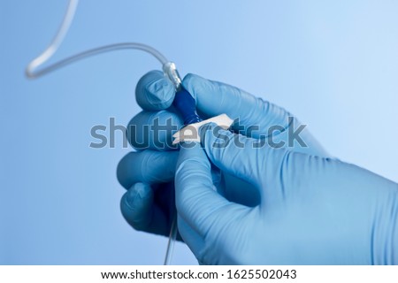 Nurse uses alchohol wipe to clean and sterilize IV medication port. Royalty-Free Stock Photo #1625502043