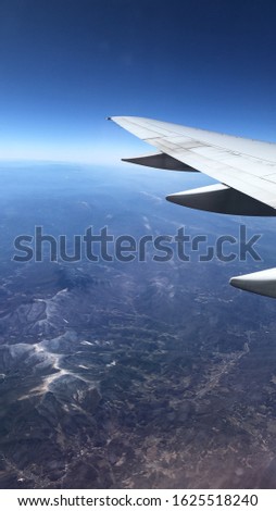 view out of a plane window over mountains