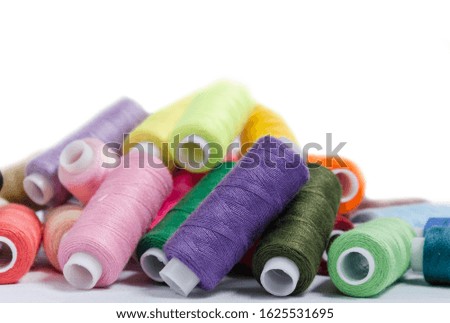 sewing threads different colors, very colorful in background, colorful background