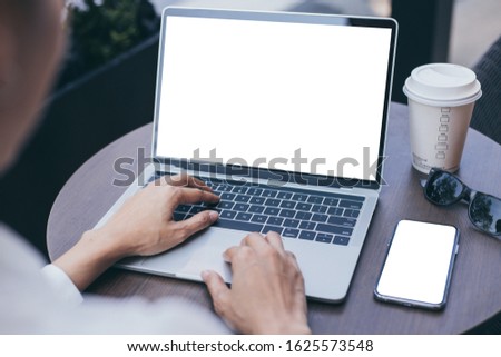 mockup image blank screen computer,cell phone with white background for advertising text,hand woman using laptop texting mobile contact business search information on desk in cafe.marketing,design