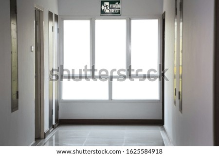 Empty interior corridor with large window.