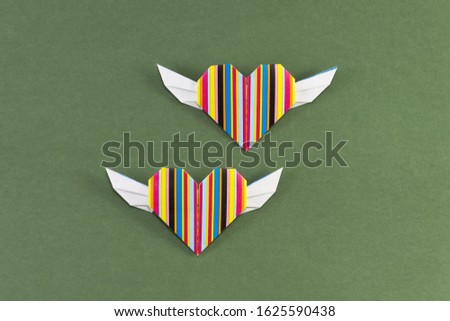 Origami paper hearts geometric volume on green background