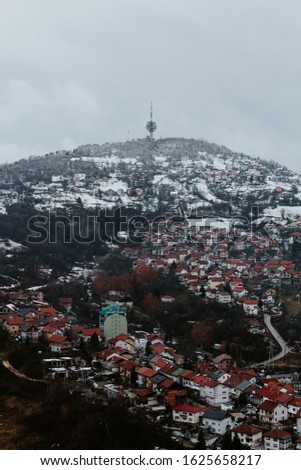 Above view of amazing city of Sarajevo. Snow covered buildings and hill.
