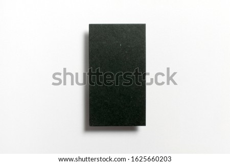 Black blank matt surface textured vertical business card flying and isolated on white background, US standard size 3.5 x 2 inches, real professional studio photo. 