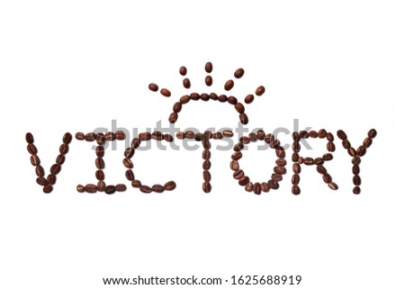 Victory quote made with roasted coffee beans placed on white background from the top view can use for your messages