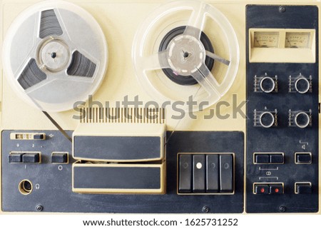 old bobbin tape recorder with magnetic tape in a wooden case Royalty-Free Stock Photo #1625731252