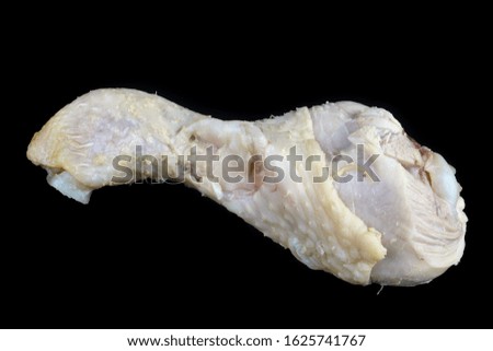 Boiled chicken leg with meat and bone  from a rustic soup  isolated  on black macro