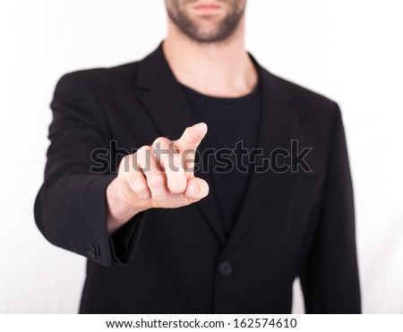 Businessman pressing an imaginary button, isolated on white