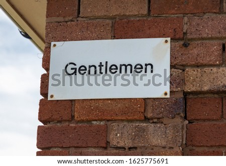 Sign on a wall indicating entrance to Mens toilet at Meols Wirral June 2019
