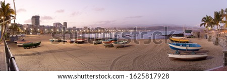 Panoramic views of the sunrise on Las Canteras beach in Las Palmas de Gran Canaria, canary islands, Spain. 
Canary and beach holidays concept. Royalty-Free Stock Photo #1625817928
