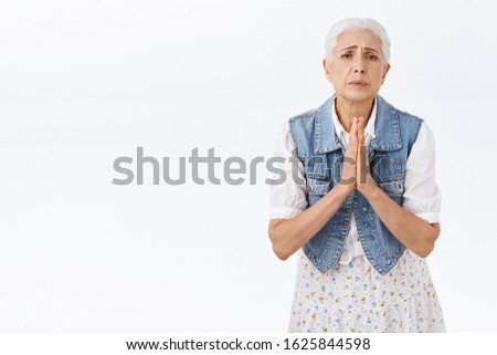 Old lady begging you for favor, need help asap. Modern grandmother asking son listen her, supplicating, plead for apology, frowning uneasy look camera with hopeful expression, white background Royalty-Free Stock Photo #1625844598